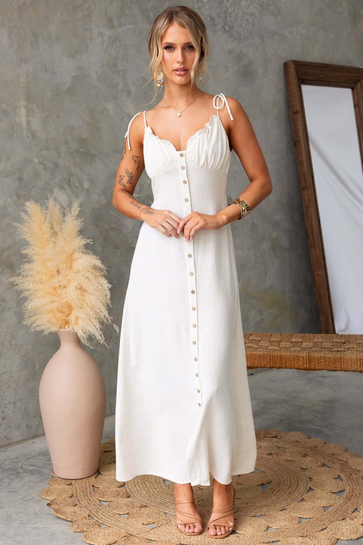 Elegant Damico Maxi Dress with tie straps, faux buttons, and front split, styled with a boho aesthetic.