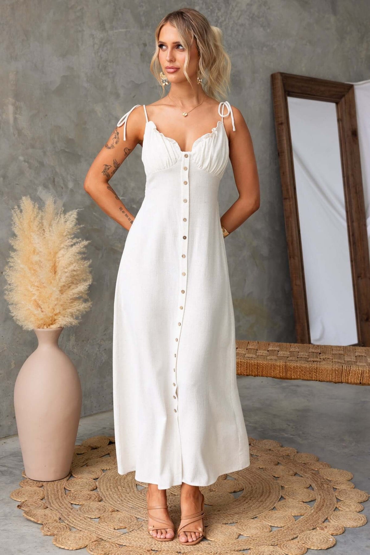 Model wearing a Damico Maxi Dress featuring tie straps, faux buttons, and a front split, set against a neutral background.