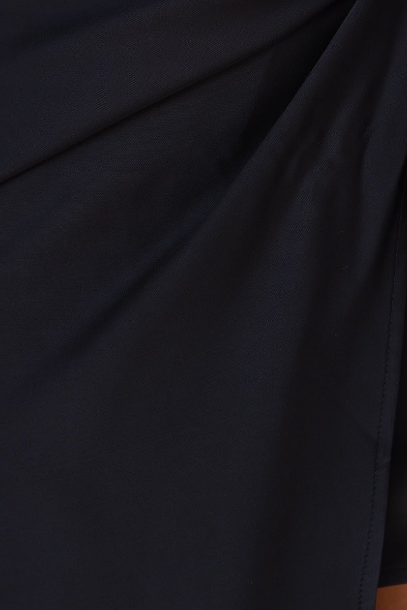 Close-up of black satin fabric showcasing smooth texture and elegant drape for the Remi Wrap Midi Dress.