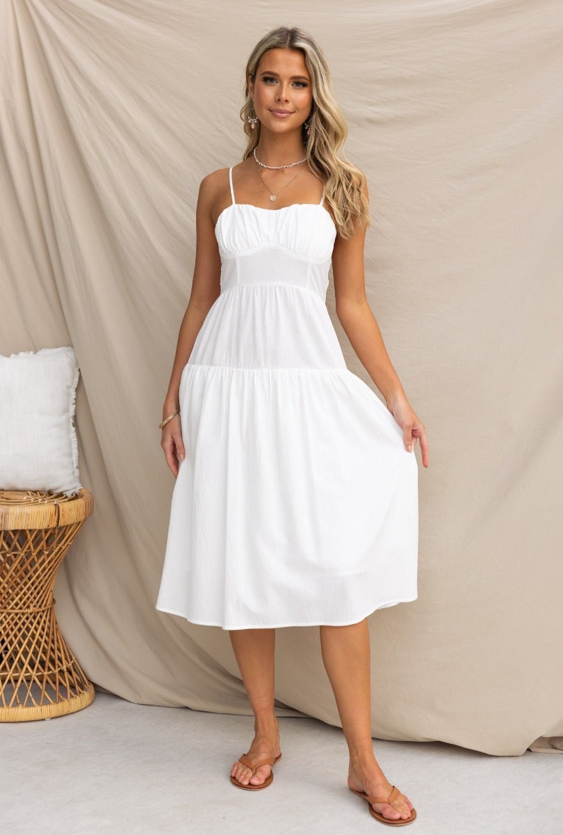 Ramilah Midi Dress: White cotton midi dress with adjustable straps and elastic back, perfect for summer outings.