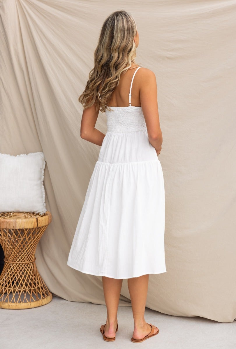 Back view of Ramilah Midi Dress featuring adjustable straps, elastic back, and linen fabric, styled with sandals.