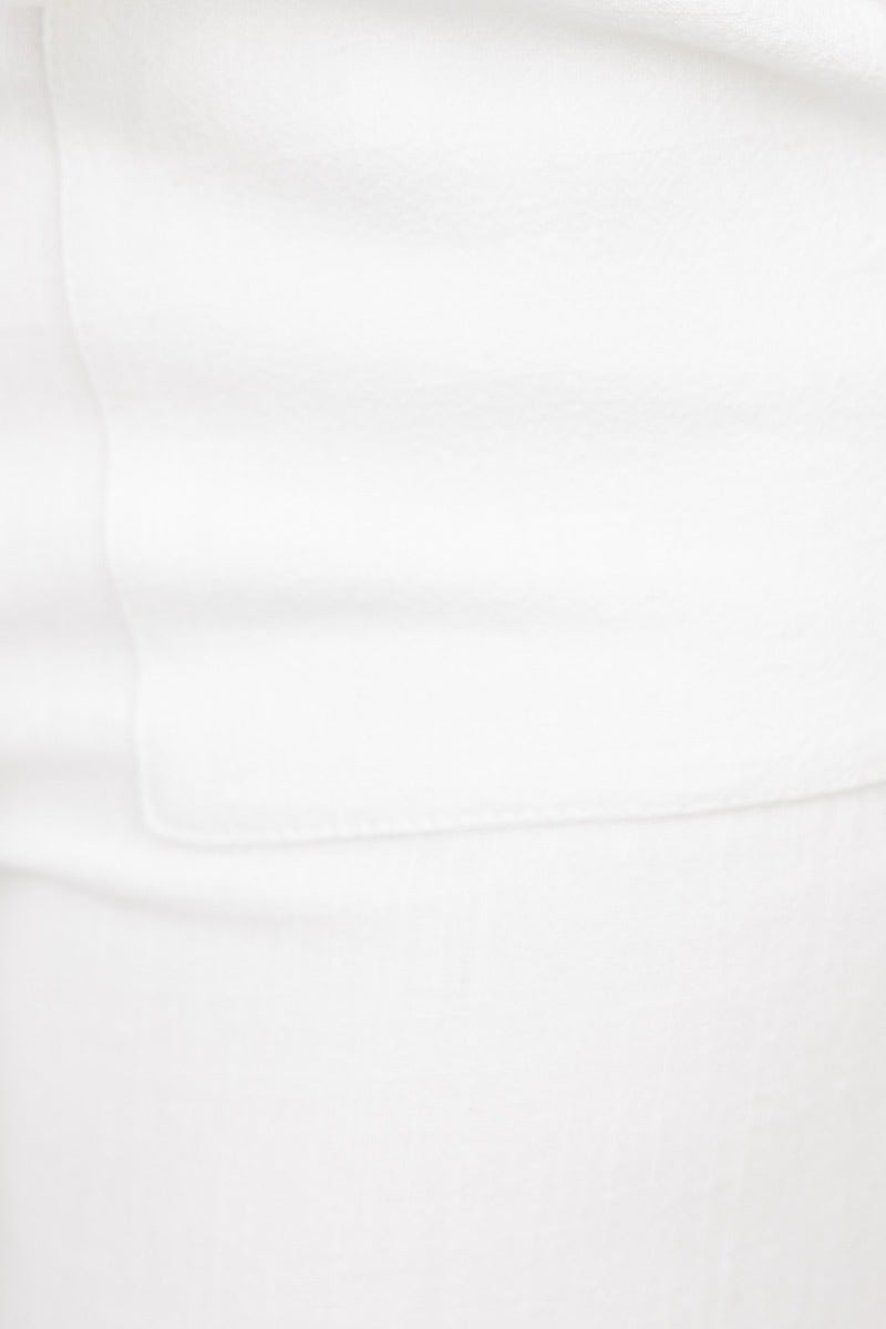 Close-up of white linen Chance Pants with a side pocket and mid-high waist fit.