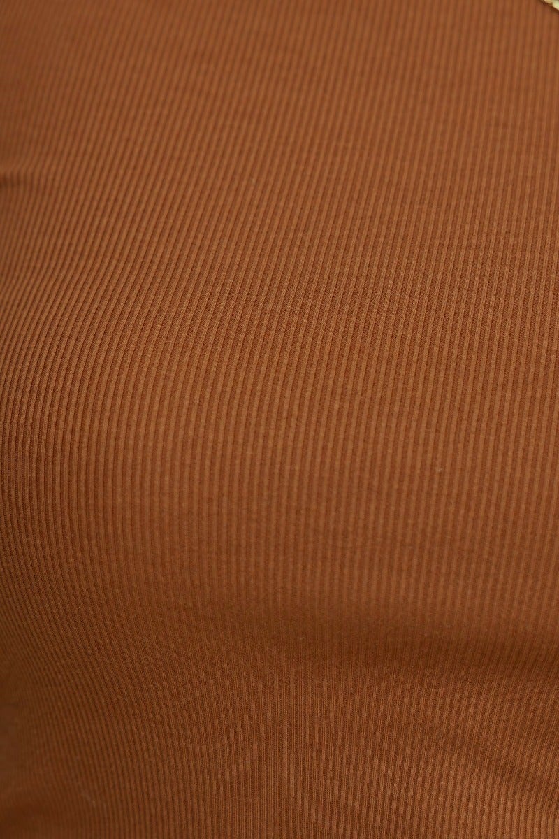 Close-up view of ribbed brown fabric of Vinny Top, showcasing its stretchy material and elegant texture.