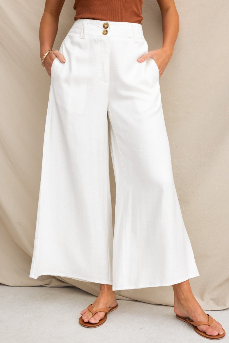 Roberts silk blend wide leg pants in white, mid-high waist with pockets, styled with a brown top.