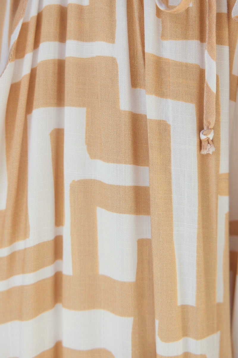 Close-up of Esmie Pants showing abstract beige and white print pattern and adjustable drawstring detail.