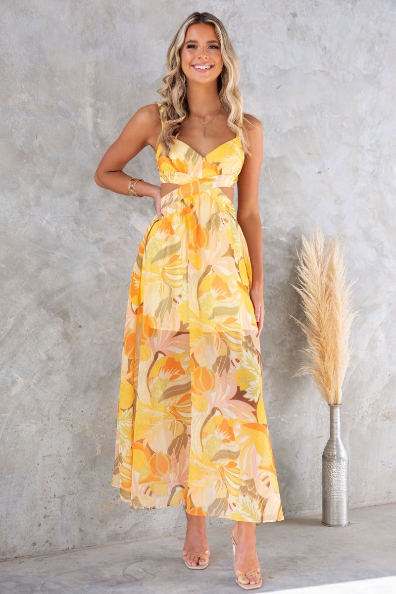 Blancia Maxi Dress in floral print, featuring cross-over tie back and cut-out waist, perfect for summer events.