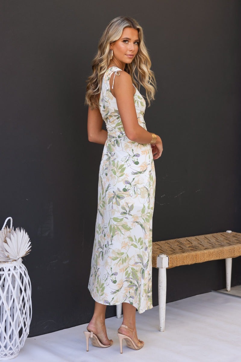 Model wearing Ronan floral print maxi dress with one-shoulder neckline and side split, showcasing elegant style.