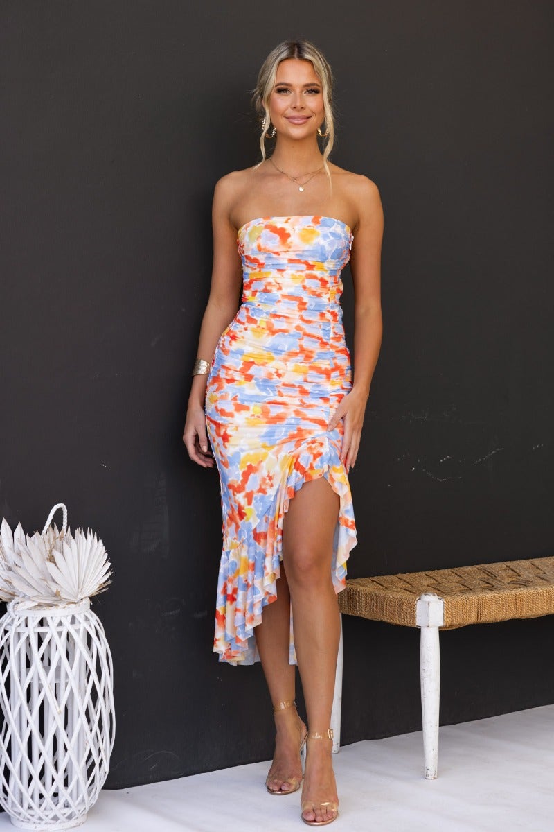 Strapless Opulence Midi Dress featuring a colorful print, high-low hem, and ruching, perfect for summer occasions.