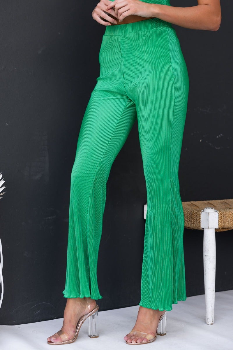 Harvie Pants in vibrant green, featuring accordion pleats, elastic waistband, and flared hem for a stylish look.