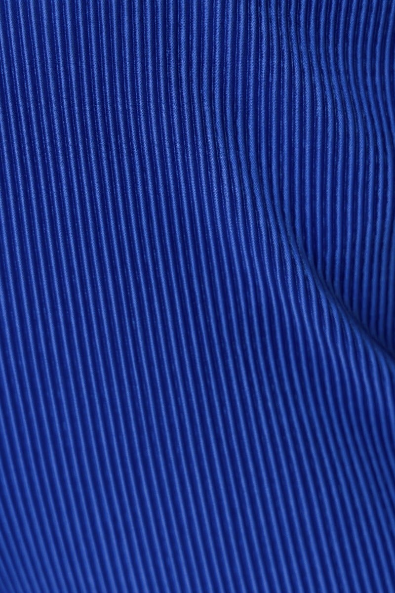 Close-up of textured blue fabric with vertical ribbing, showcasing the material details of the Harvie Pants.