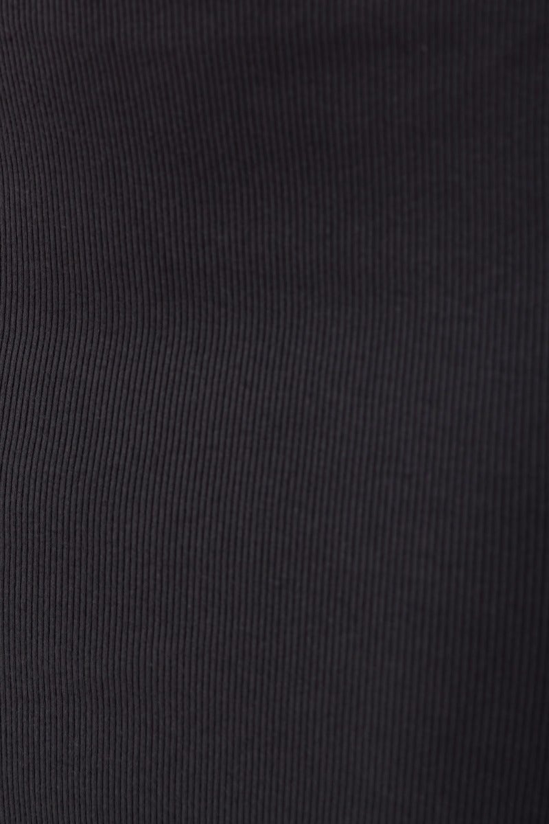Dark grey ribbed fabric texture of the Naira Midi Dress, showcasing stretch material for a comfortable fit.