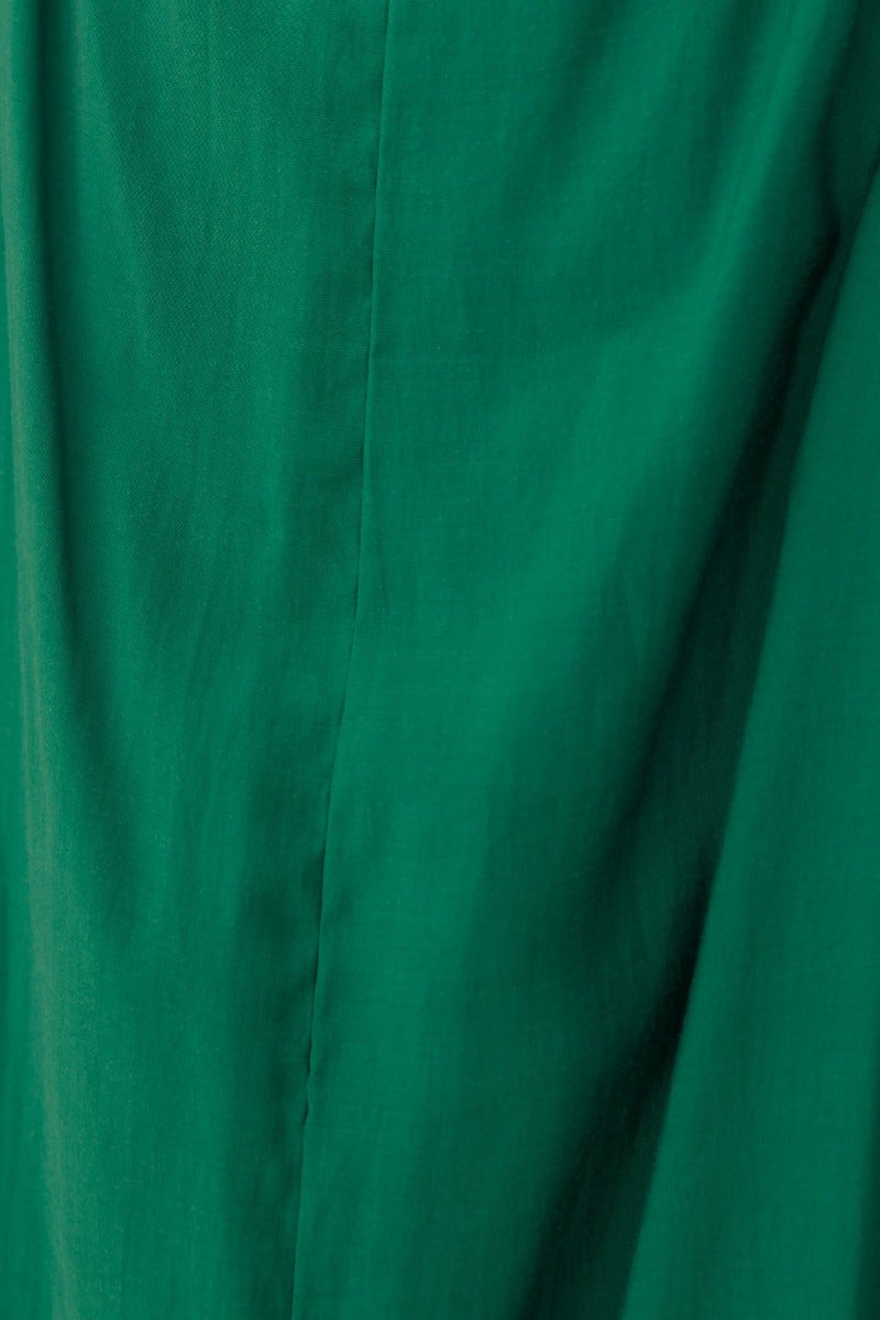 Close-up of the soft green fabric of the Silvena Maxi Dress, showcasing its smooth texture and vibrant color.