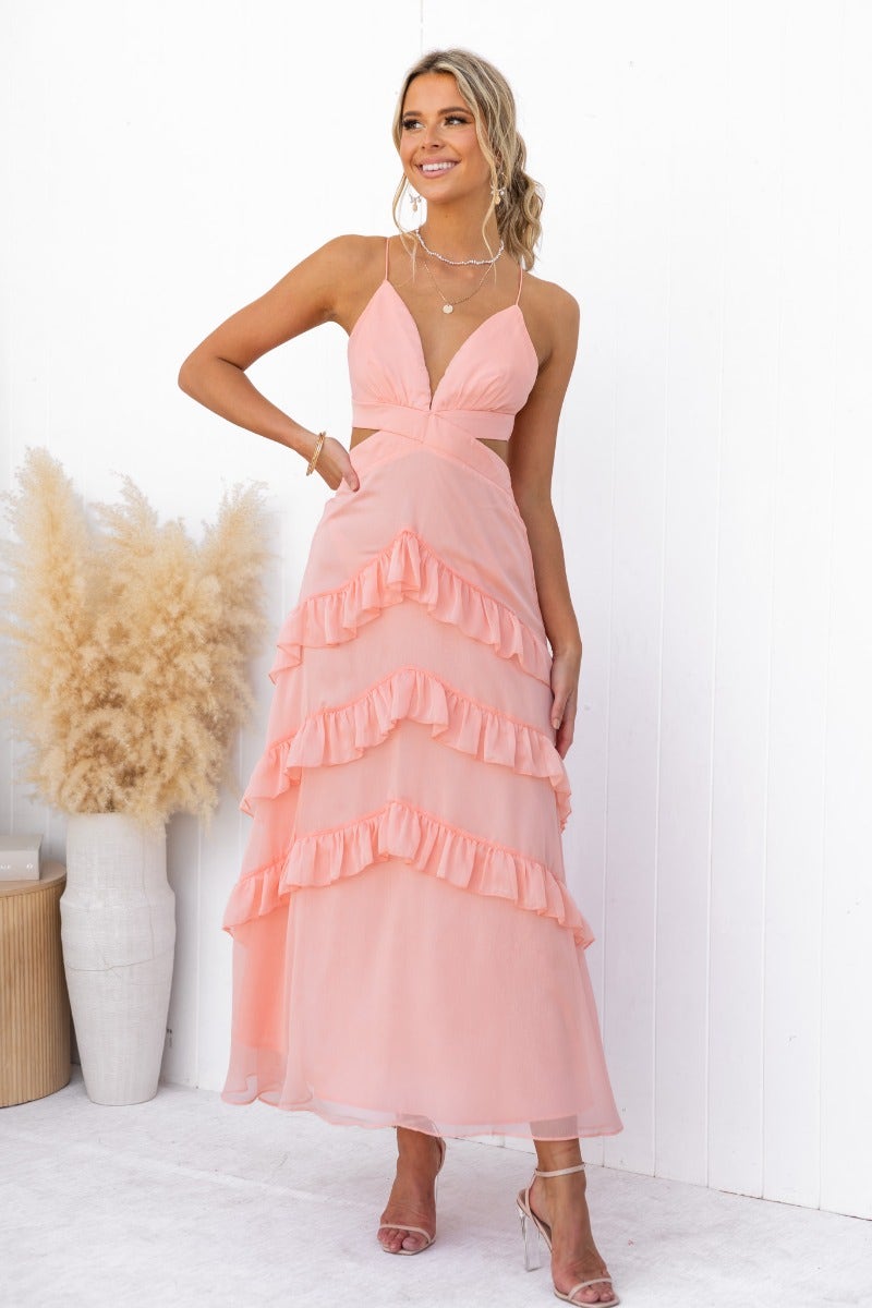 Blaze Maxi Dress featuring V-neckline, adjustable straps, cut-out waist, and ruffled skirt in soft pink color.
