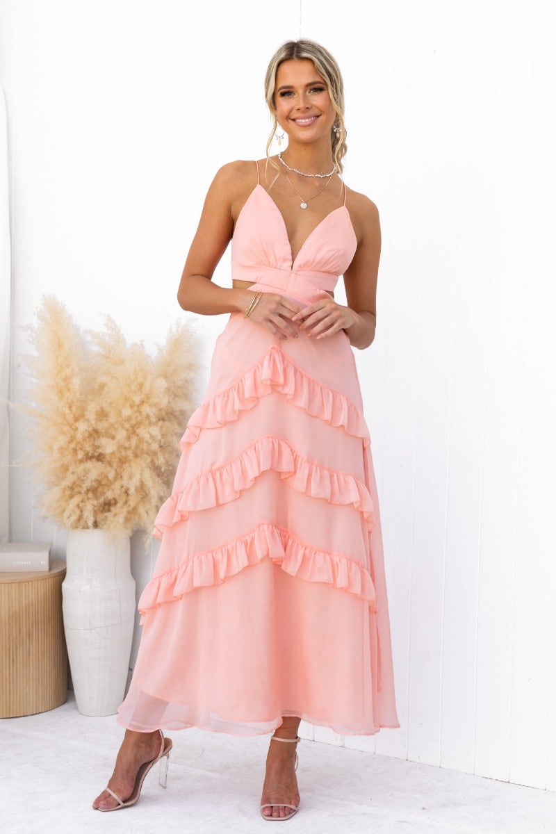 Blaze Maxi Dress in soft pink with V-neckline, ruffled skirt, and adjustable straps, perfect for summer occasions.
