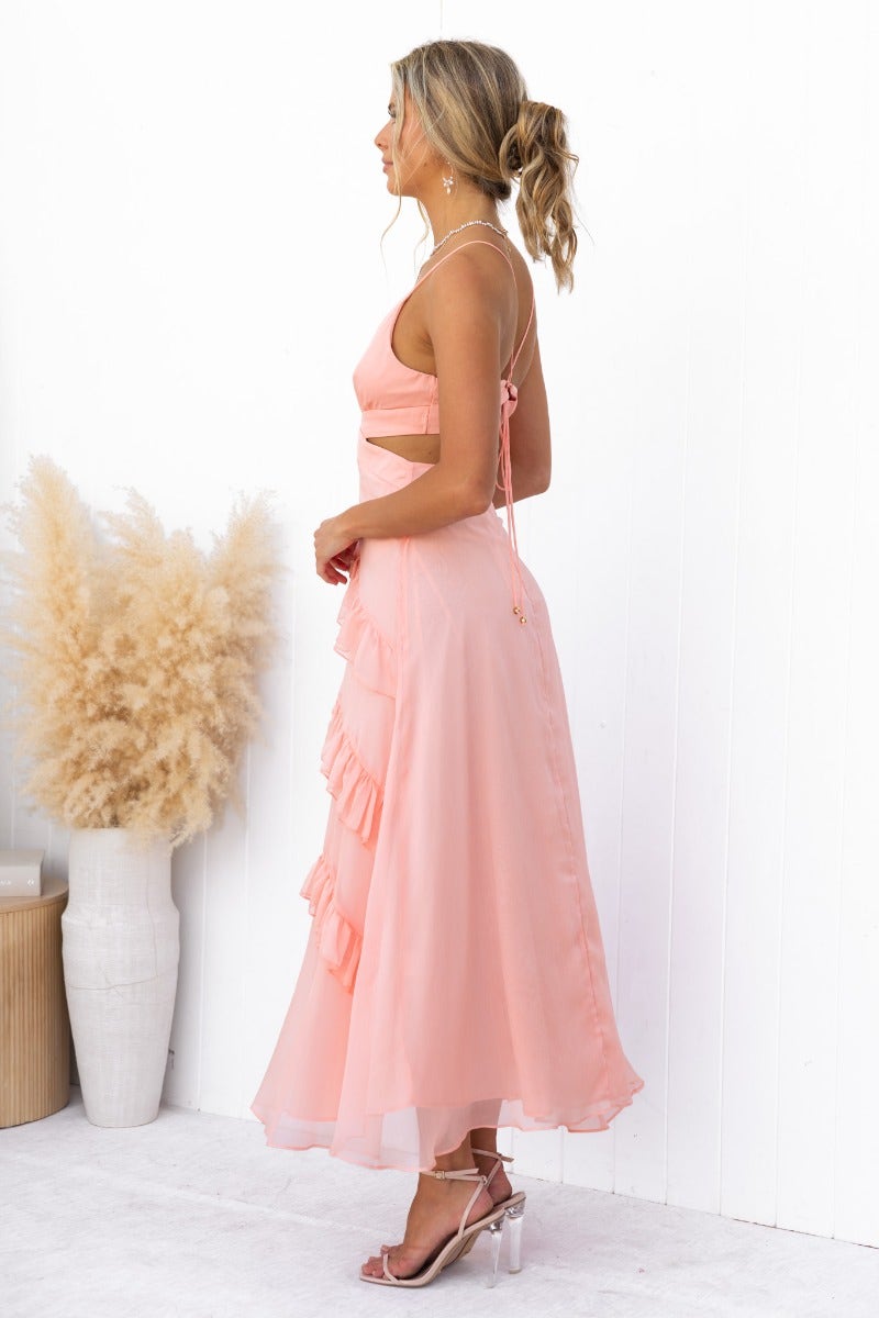 Blaze Maxi Dress in soft pink with ruffle detail, V-neckline, and adjustable tie straps, perfect for summer events.