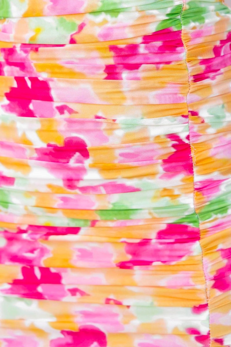 Close-up of colorful floral ruching on the Opulence Midi Dress, featuring vibrant pink, yellow, and green patterns.