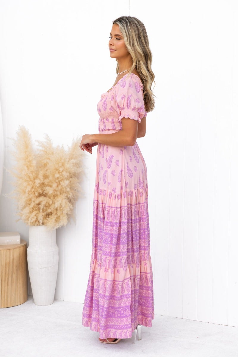 Side view of a multi-colour maxi dress with elastic bodice and sleeves, styled elegantly against a minimalist background.