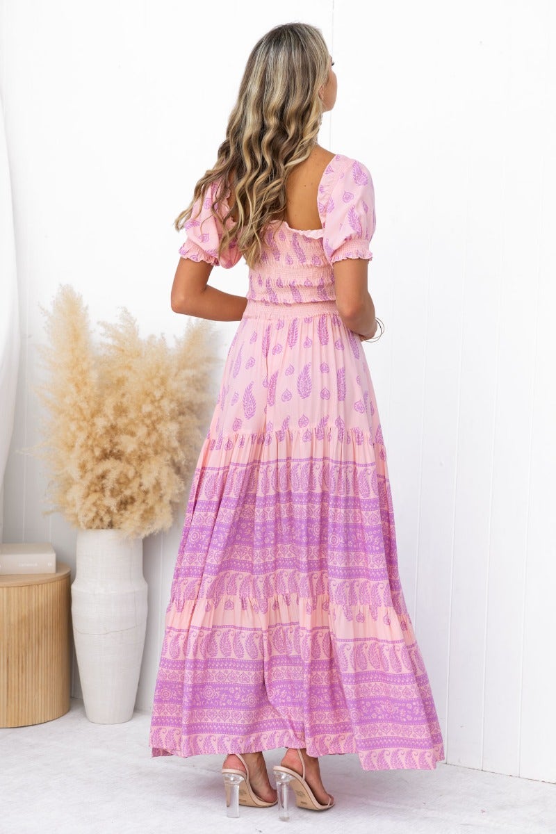 Woman wearing a multi-colour Right Time Maxi Dress with elastic bodice and puff sleeves, showcasing the back view.