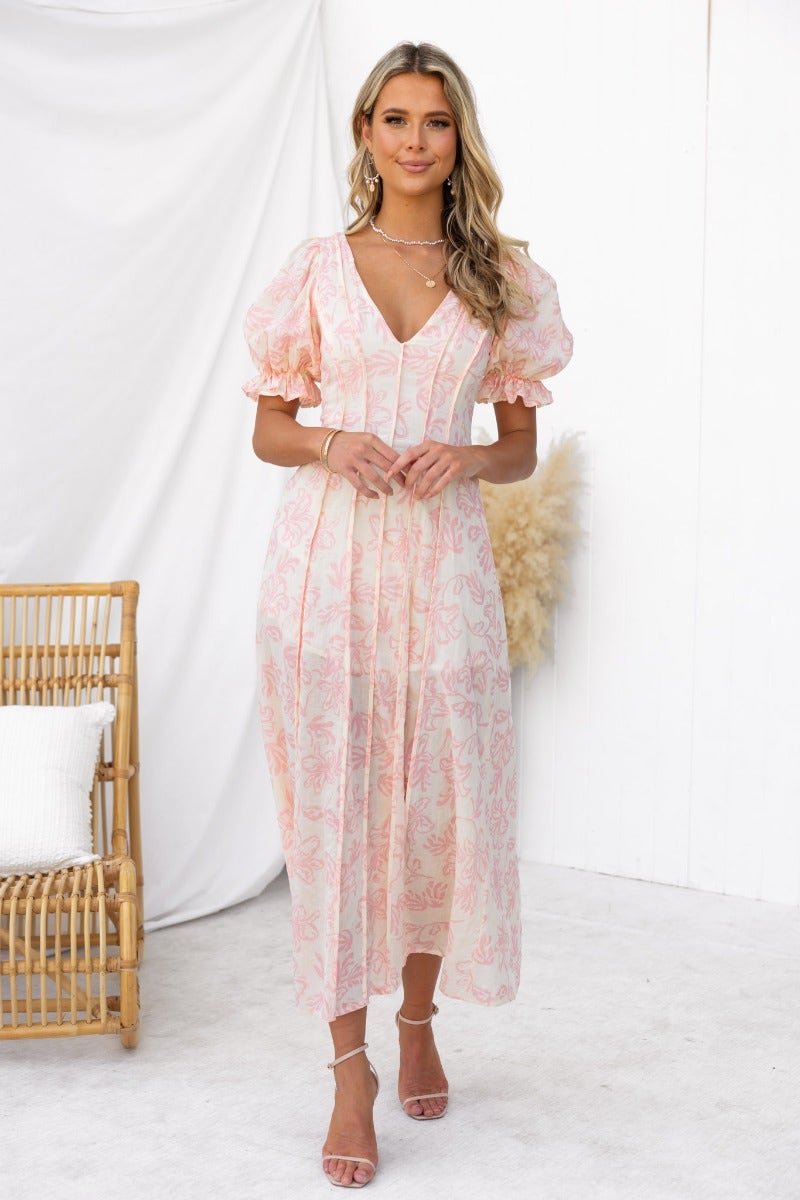 Model wearing Adaline Maxi Dress, a floral print V-neckline dress with puff sleeves and invisible zip, styled for summer.