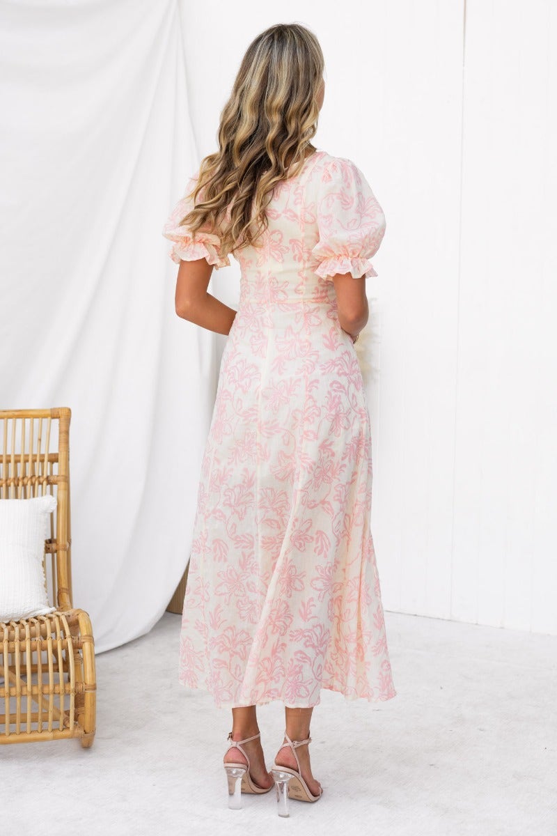 Back view of Adaline Maxi Dress in floral print with puff sleeves, showcasing a flowing design and elegant style.