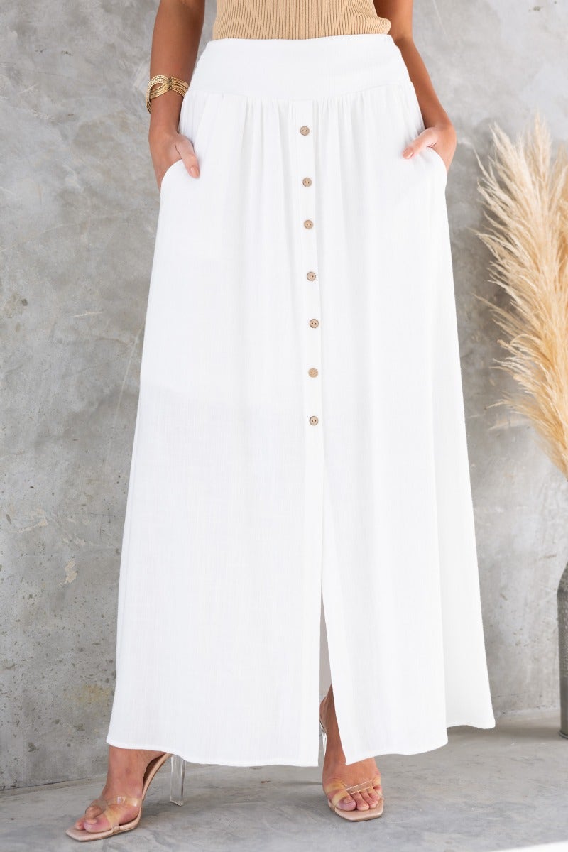 Dalila Maxi Skirt in white, featuring faux button-up front, pockets, and a stylish slit.