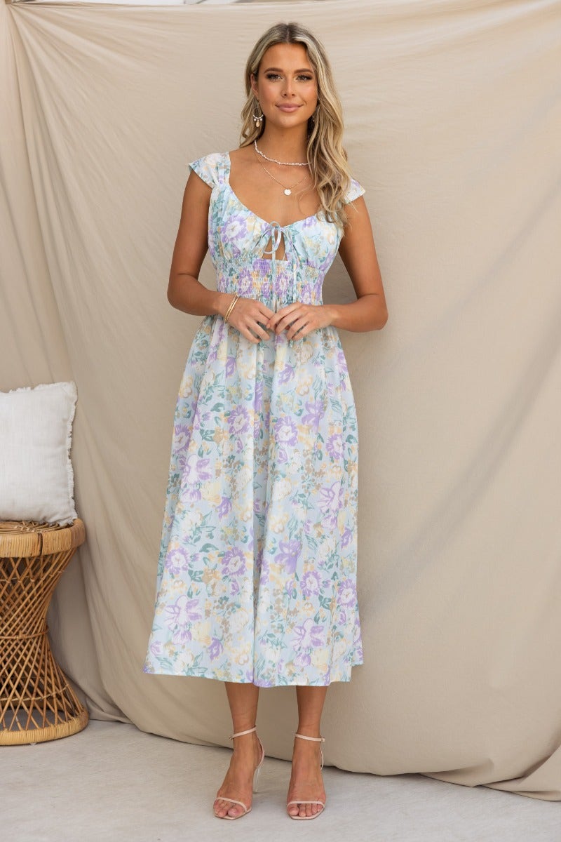 Model wearing a floral print Sweet Nothing midi dress with tie detail and keyhole, styled for a casual look.