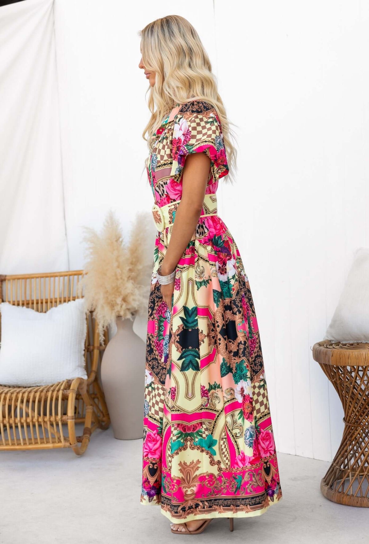 Side view of Palermo Maxi Dress featuring vibrant floral patterns and pockets, perfect for a relaxed summer look.