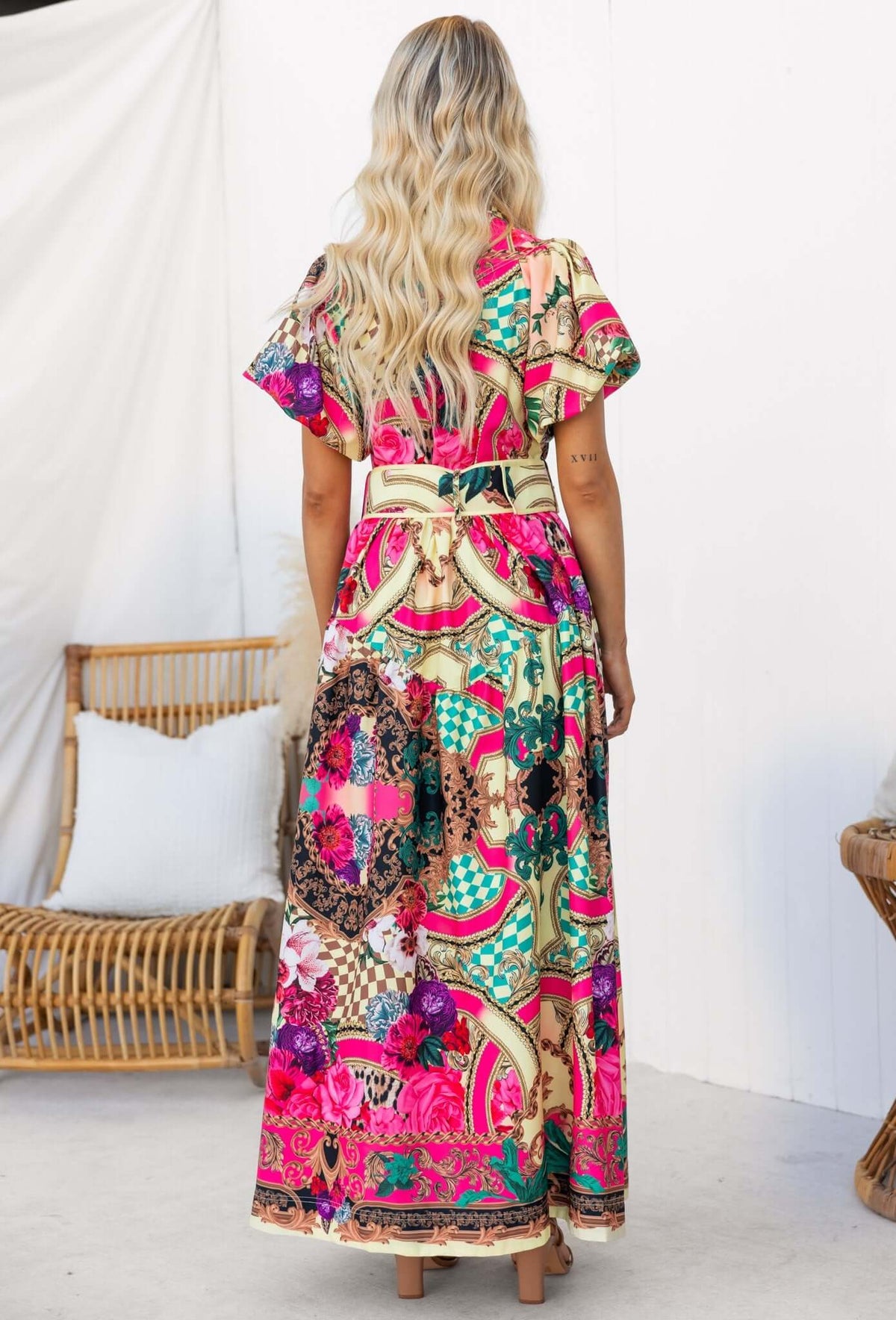 Back view of Palermo Maxi Dress featuring vibrant patterns and removable belt, styled with relaxed fit.