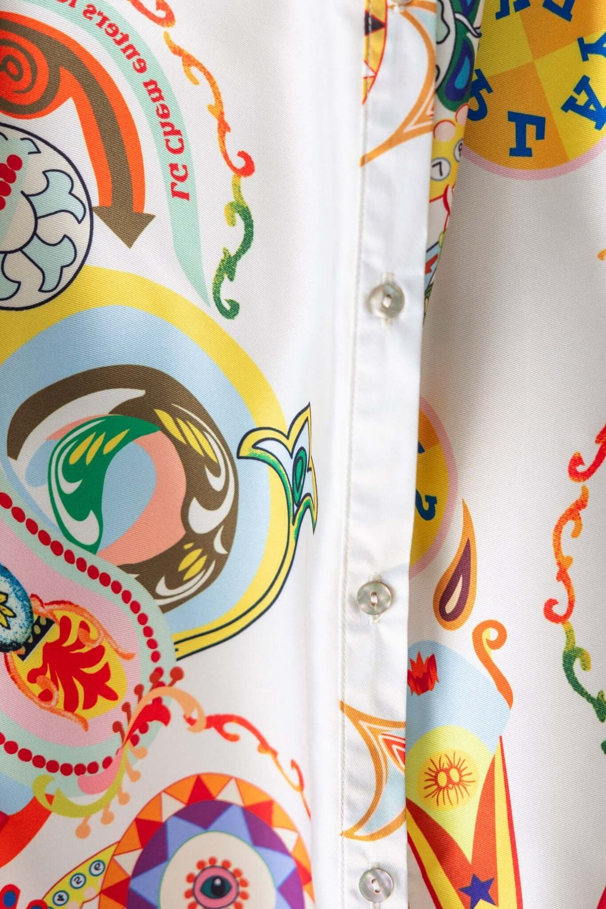 Colorful patterned fabric detail featuring button closure on Kiton Maxi Dress, showcasing vibrant designs.