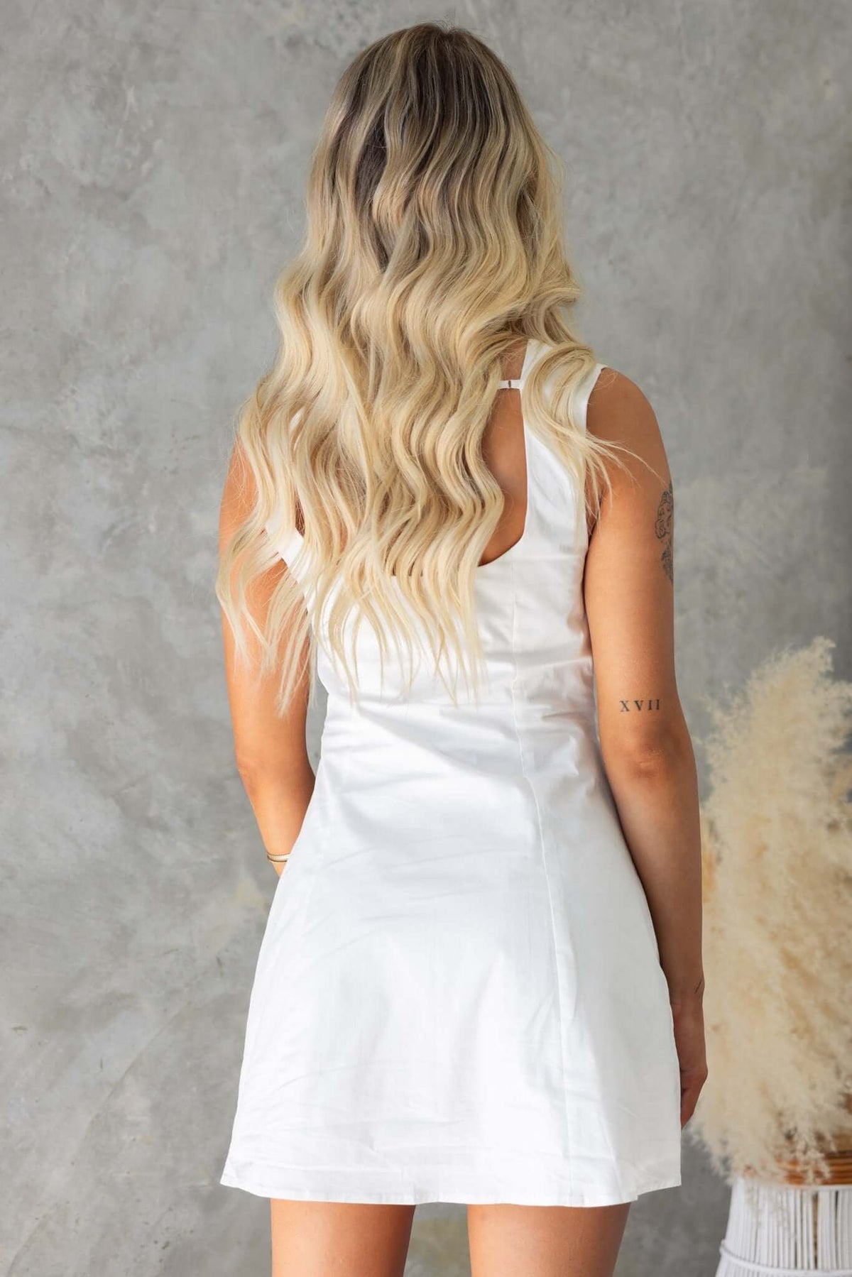 Back view of the elegant Saint Mini Dress in white, featuring adjustable straps and a flattering fit.