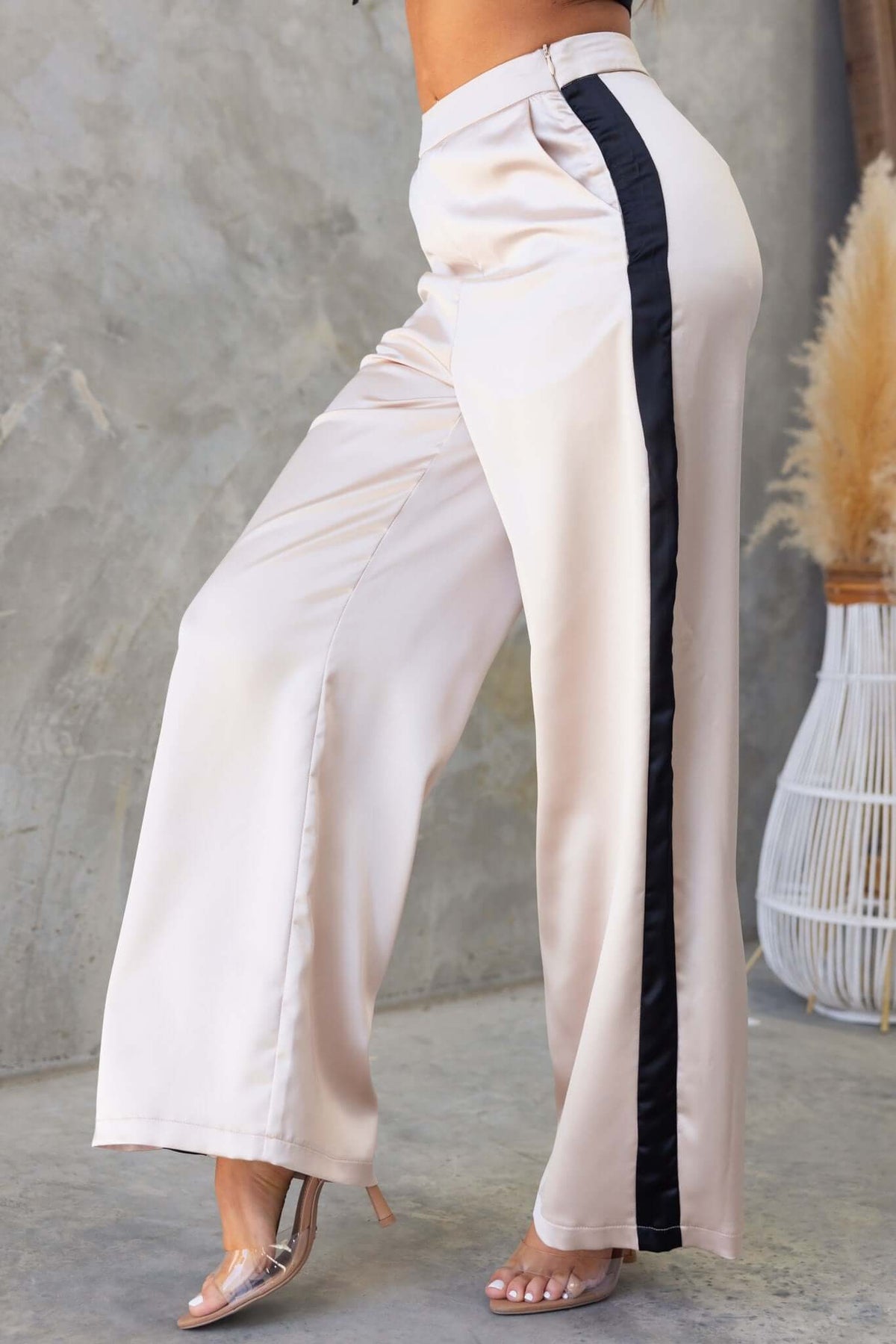 Tanaya Pants in beige with black satin stripes, featuring a mid-high waist fit and side pockets.