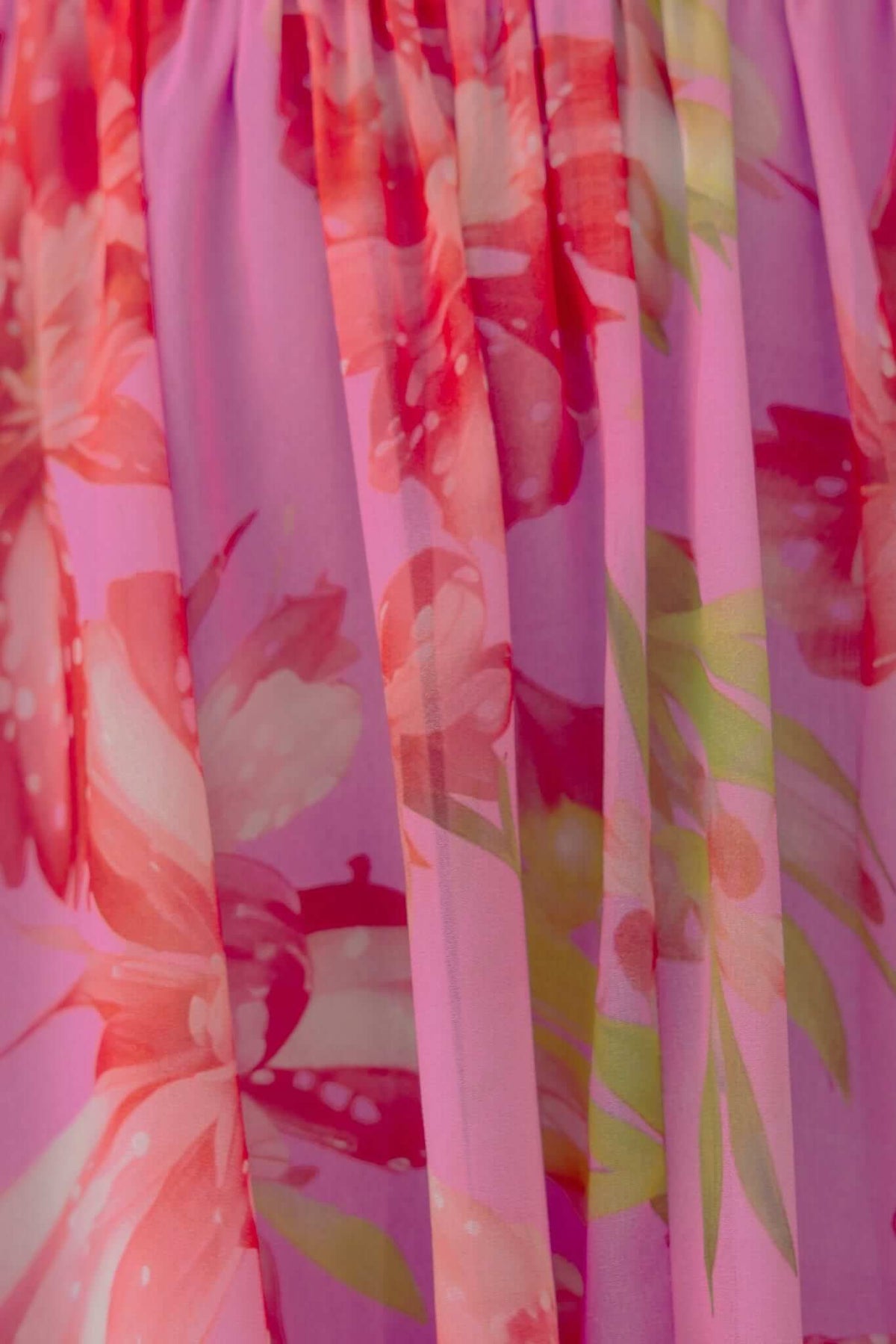 Close-up of the vibrant floral pattern on the Giulianna Maxi Dress, featuring shades of pink and green.