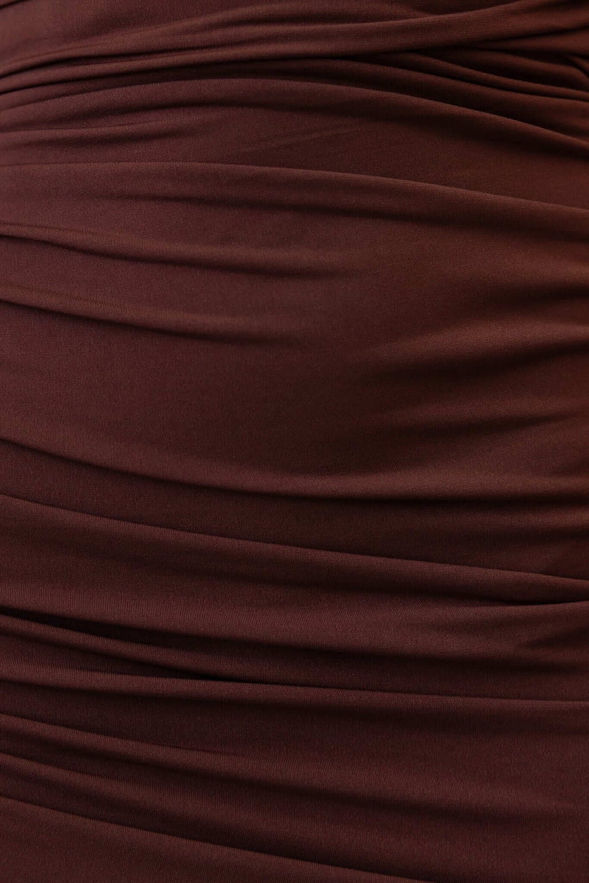Close-up of the gathered ruching and stretch fabric in a brown midi dress highlighting its elegant design.