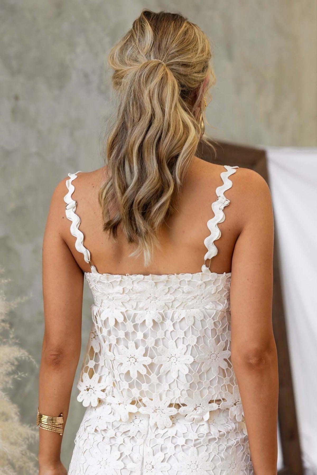 Back view of a woman wearing the Xenni Top with adjustable straps and floral anglaise material.