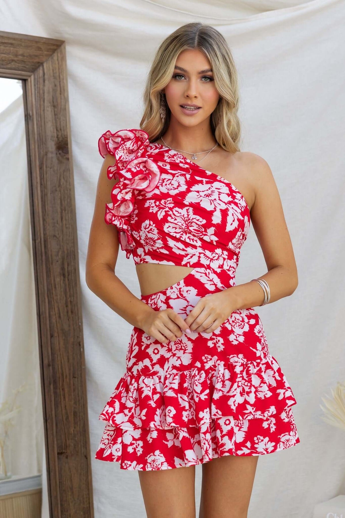 One-shoulder Meriden Dress with floral pattern and ruffle details, perfect for summer occasions.