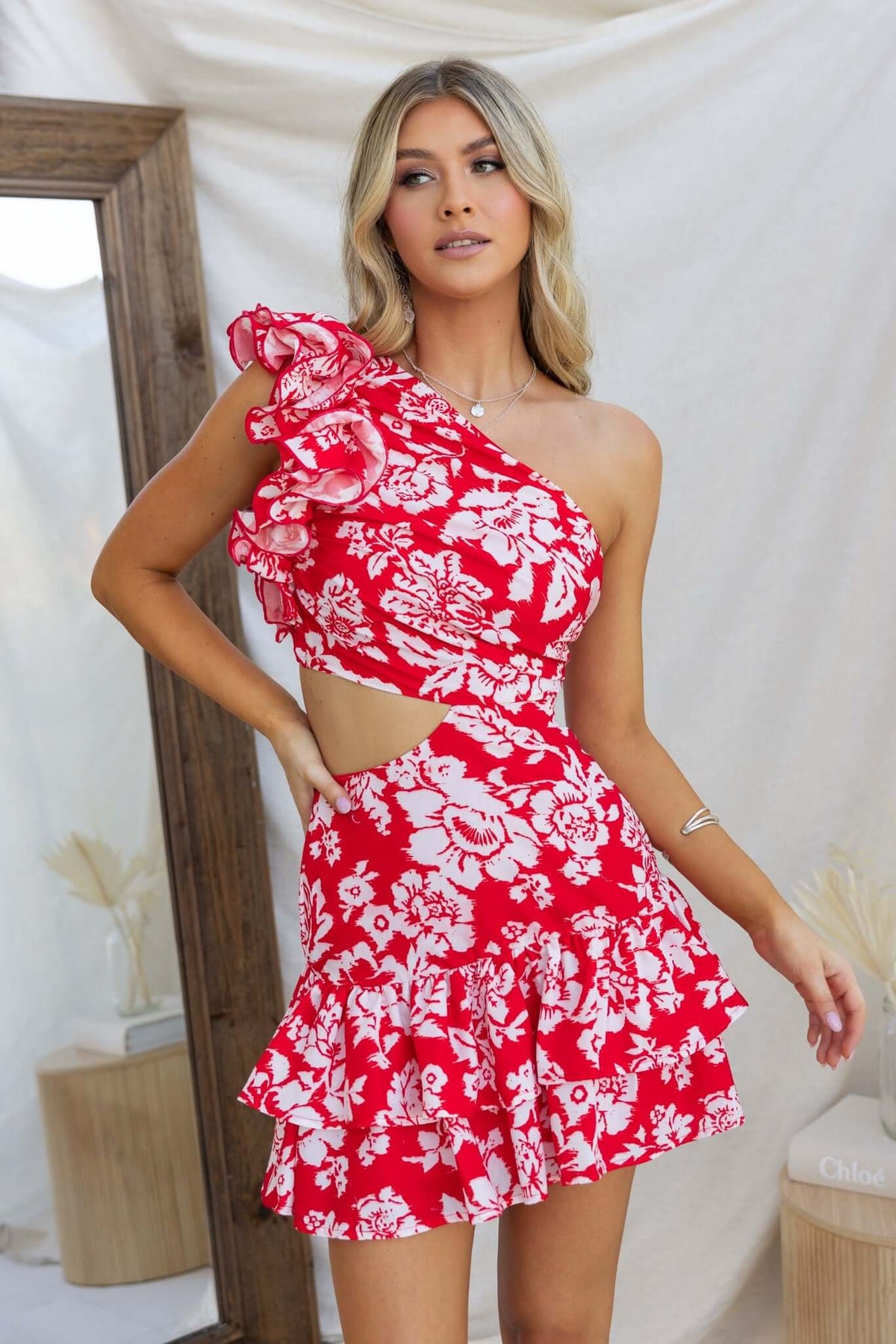 Meriden Dress featuring one-shoulder neckline, floral print, and cut-out waist, perfect for summer occasions.