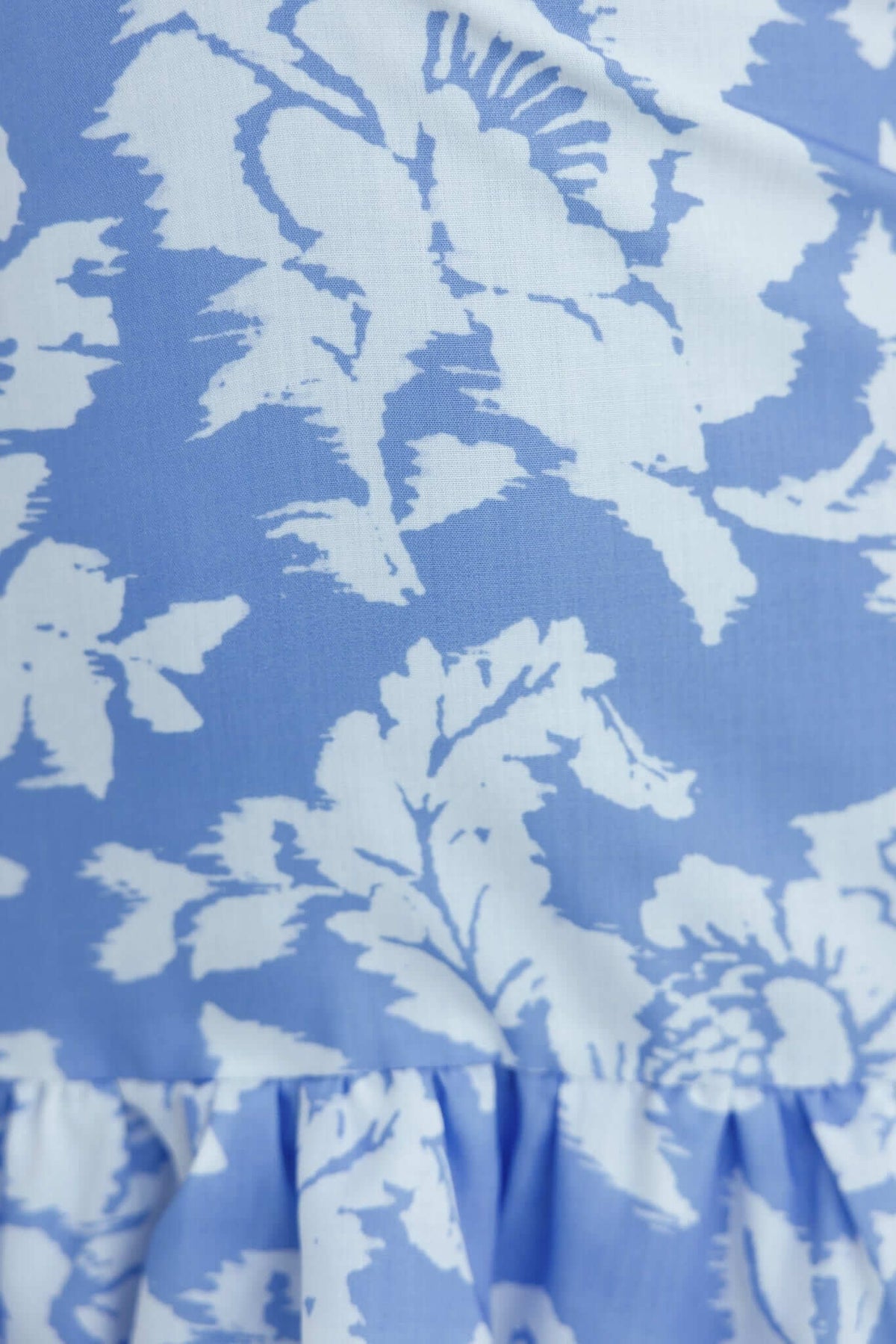 Close-up of floral fabric in soft blue and white, ideal for the Meriden Dress, showcasing its elegant print detail.