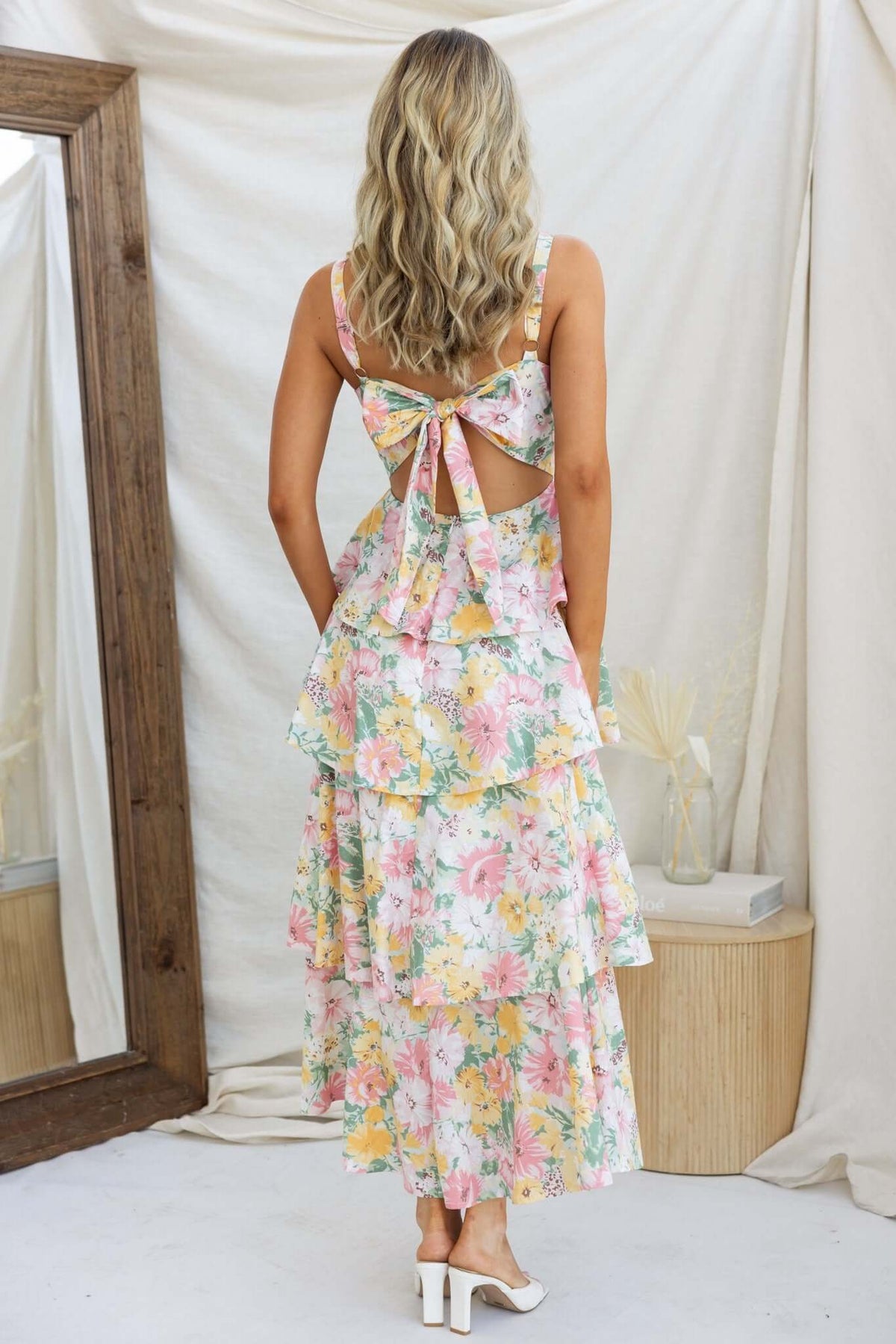 Back view of Peyton Maxi Dress with multi-tier ruffle skirt and adjustable tie, featuring floral print and open design.