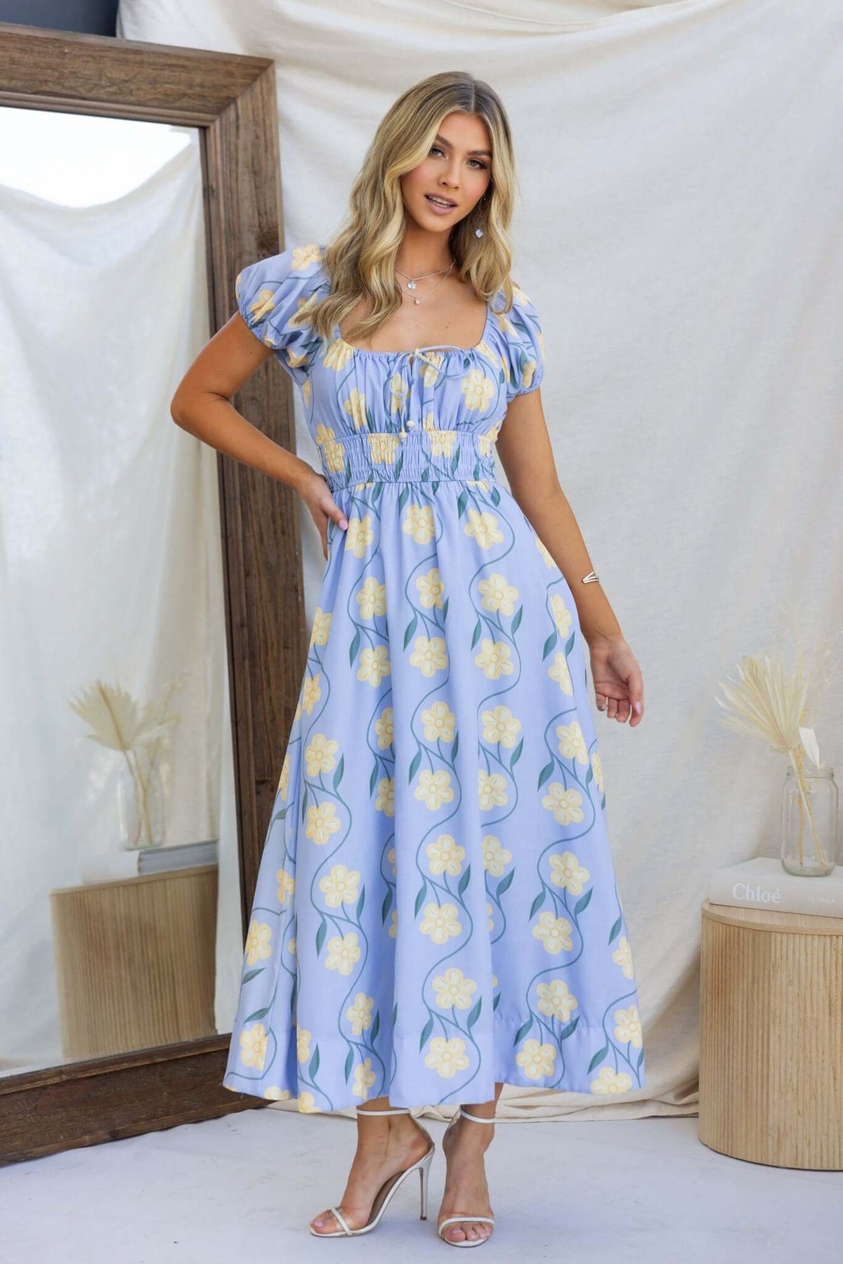 Elkhart Maxi Dress featuring a floral print, elastic bodice, and a relaxed fit, styled in soft cotton fabric.