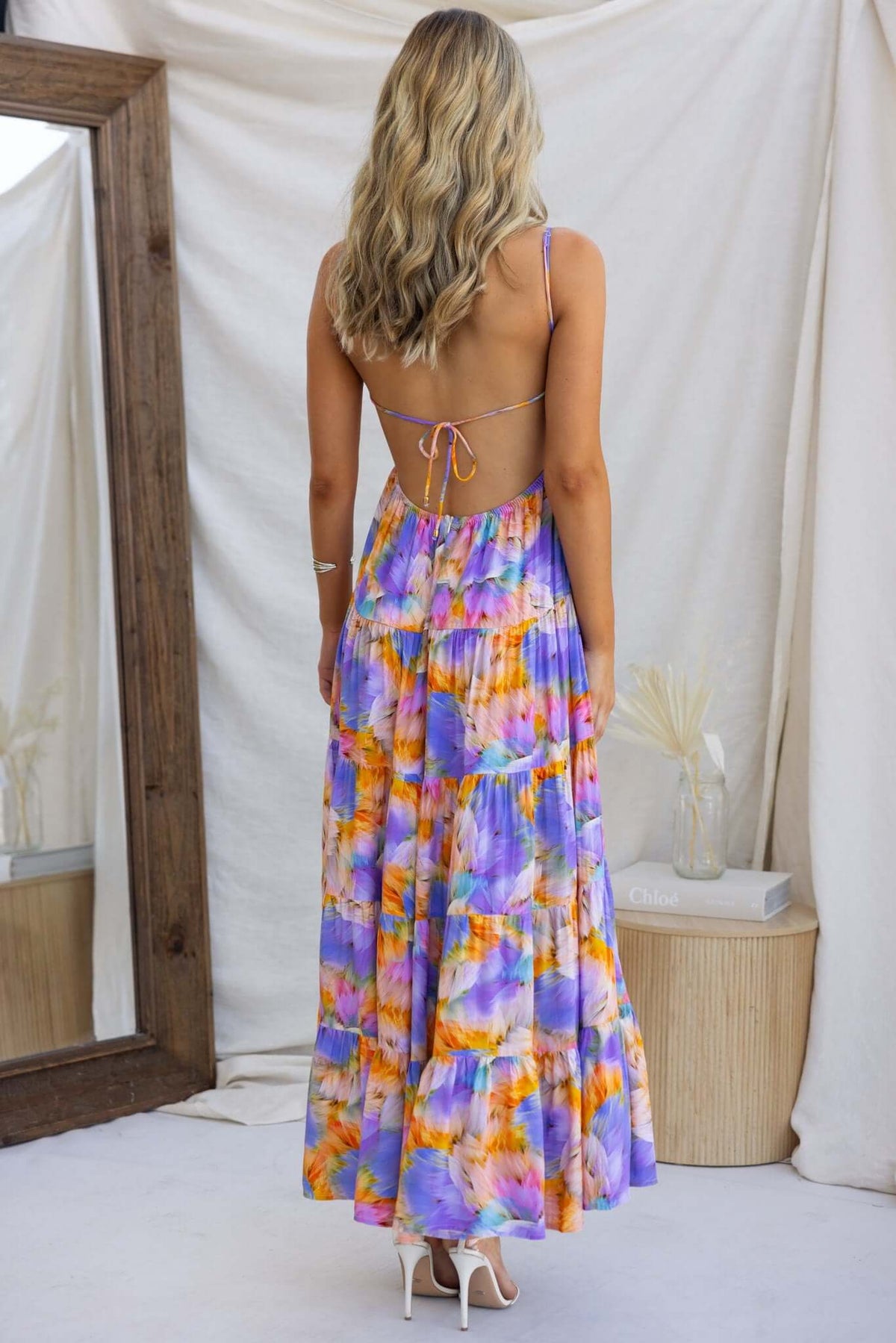 Emmelina Maxi Dress with adjustable straps and tie back, showcasing colorful print and elegant flow.