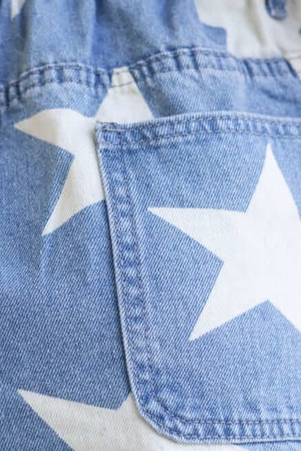 Close-up of Alabama denim shorts featuring a star pattern and pocket detail.