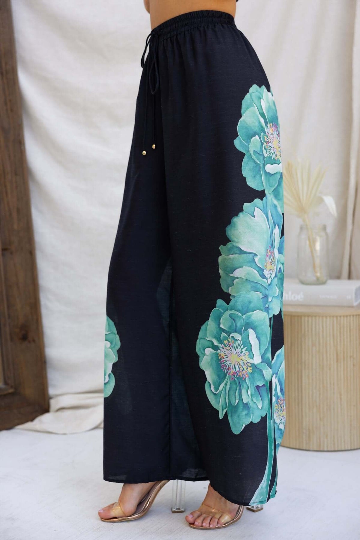 Faly Pants: Black lightweight cotton trousers with floral design, mid-high waist, and elastic waistband, perfect for summer wear.