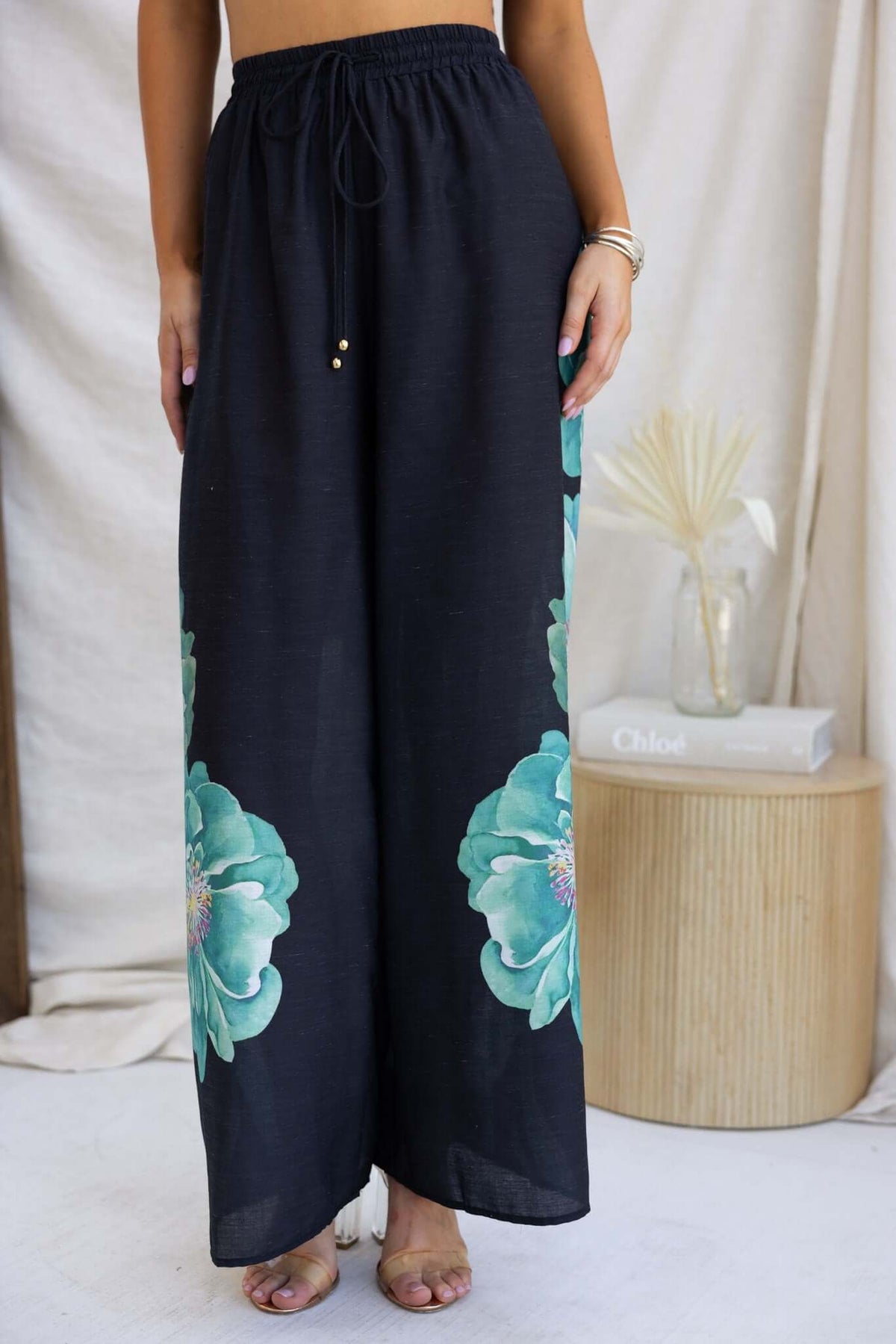Stylish black Faly Pants featuring vibrant floral designs, perfect for a lightweight summer look.