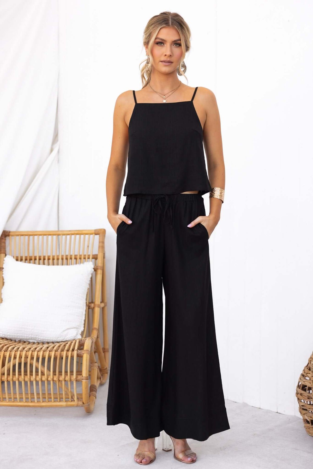 Model wearing Frances Pants in black with pockets and elastic waistband, styled with a matching top.