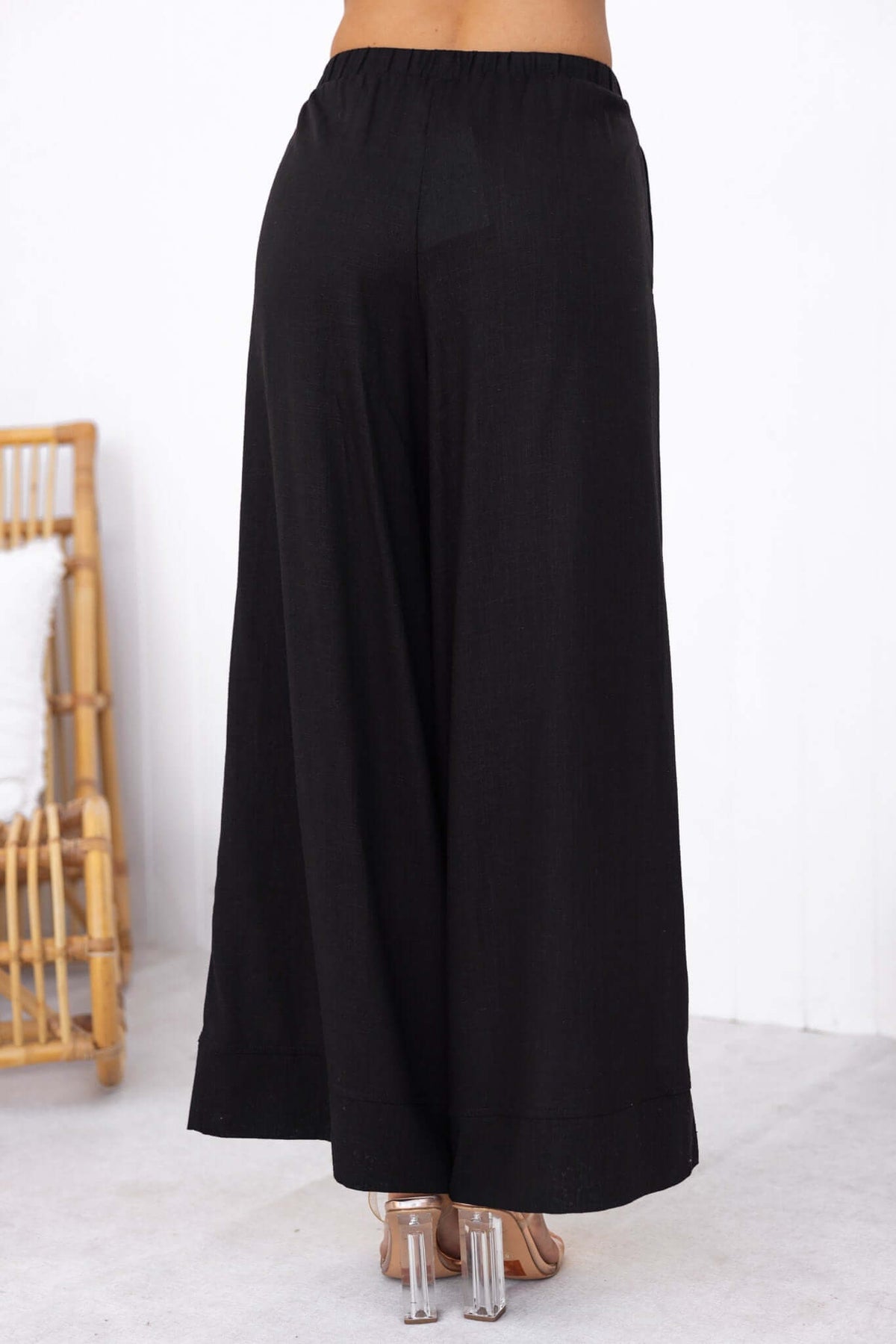 Black Frances Pants featuring an elastic waistband and wide-leg design, showcasing a linen look.