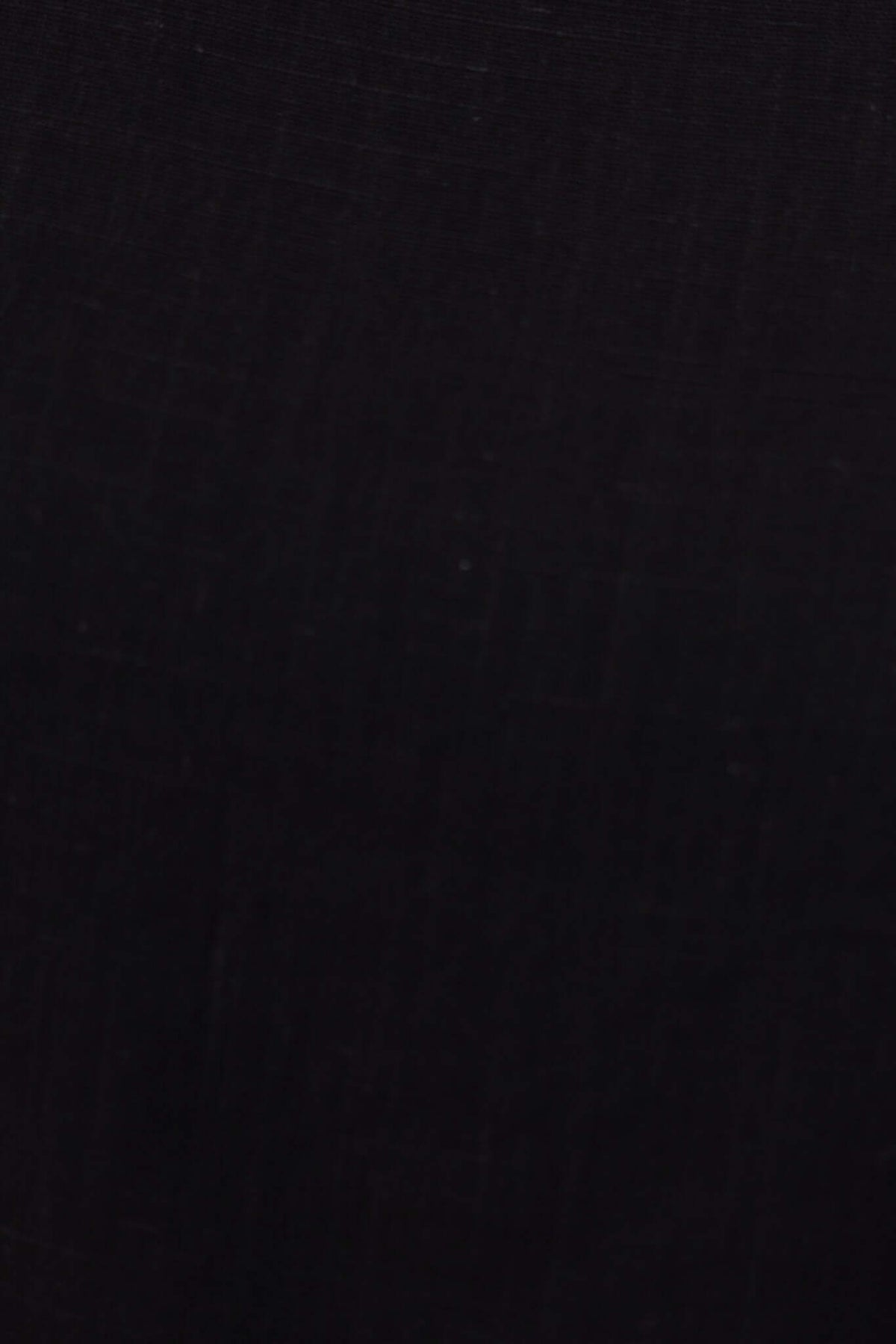 Close-up of black linen fabric showcasing texture for Frances Pants with elastic waistband and pockets.