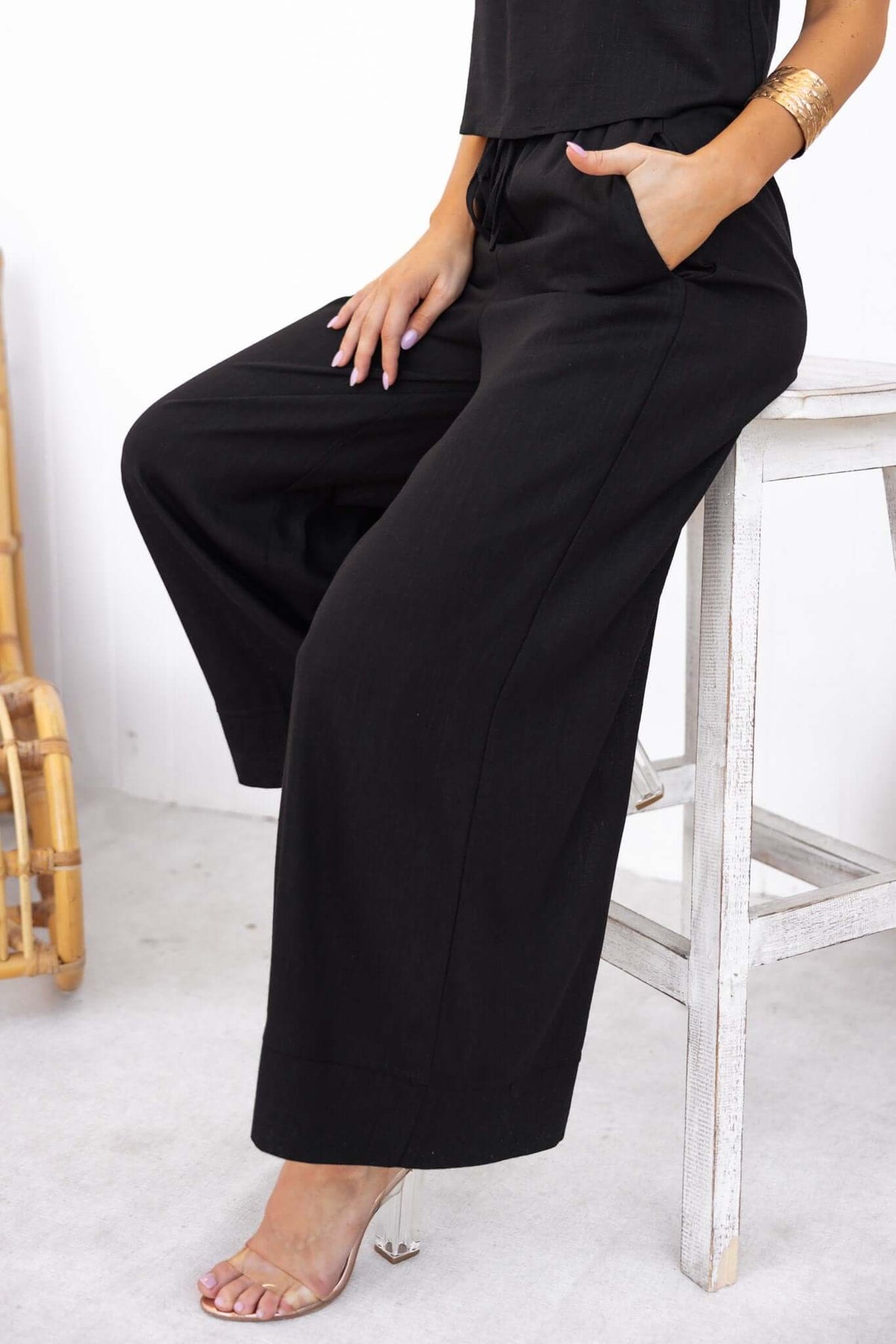 Frances Pants in black with an elastic waistband and pockets, featuring a linen look and feel.
