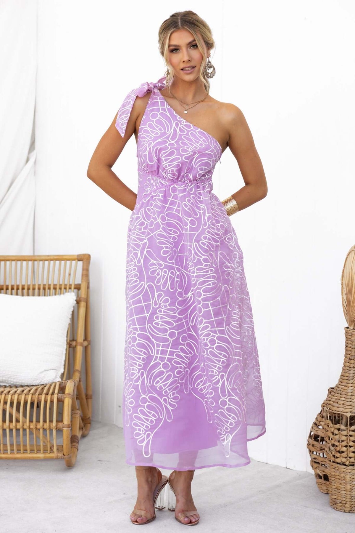 Haraka Midi Dress, one-shoulder design with tie strap, featuring chiffon material and floral embroidery in lavender color.