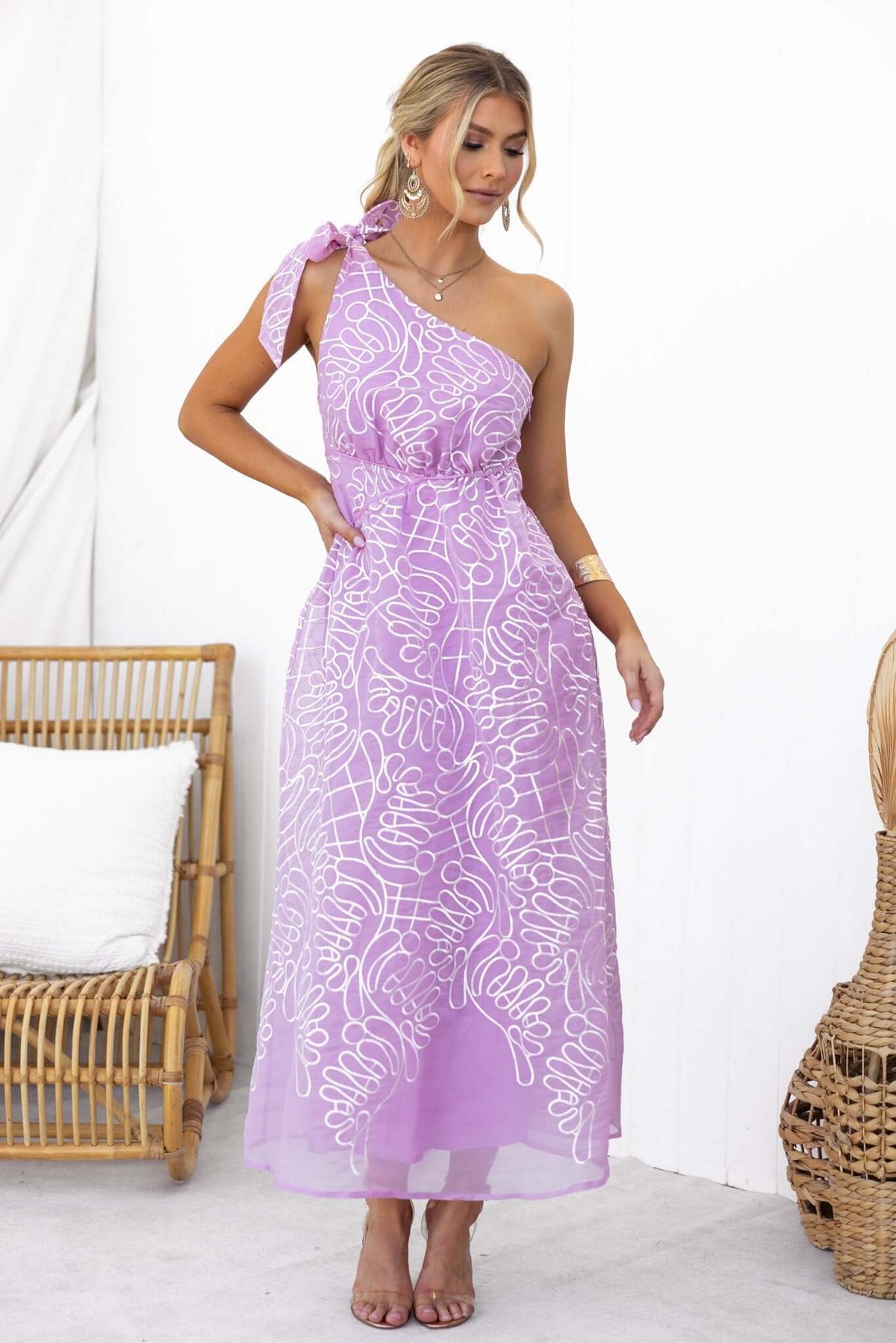 Stylish Haraka Midi Dress in lavender with one-shoulder design and tie strap, showcasing a floral pattern.