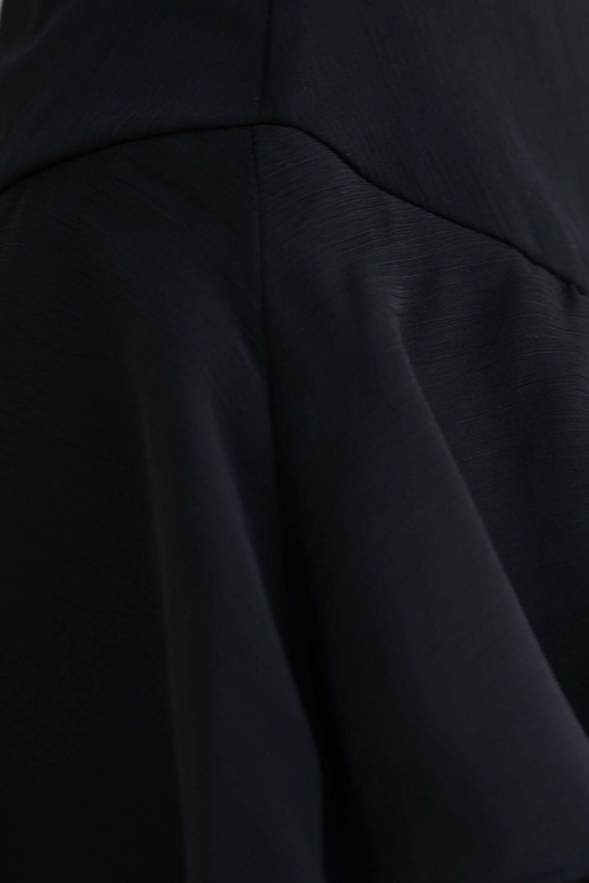 Close-up of the flowing skirt detail of the Saphina Maxi Dress in black chiffon with multi-tier ruffles.
